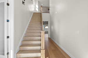 Stairs featuring wood-type flooring