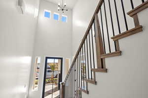 Entryway featuring a towering ceiling and a notable chandelier