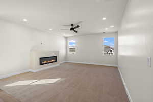 Theater room/loft featuring ceiling fan and a fireplace