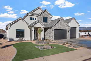 View of front facade with a front lawn and a garage