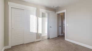 Unfurnished bedroom with carpet