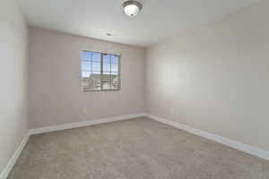 View of carpeted spare room