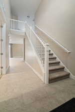 Stairway featuring a high ceiling