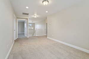 Empty room with light colored carpet