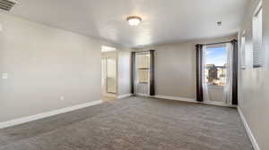 Unfurnished bedroom with light carpet