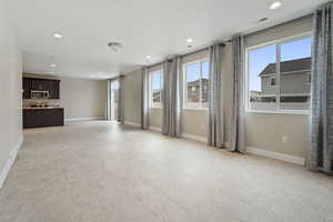 Unfurnished living room with light tile patterned floors