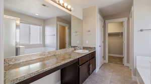 Bathroom with independent shower and bath, tile patterned flooring, and vanity