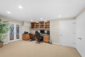 Carpeted office space with french doors