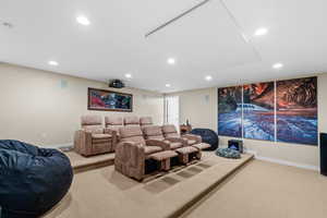 Home theater room with light carpet