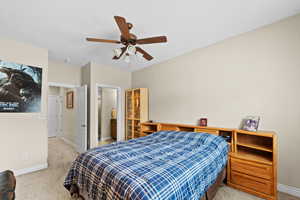 Bedroom with ceiling fan and light carpet