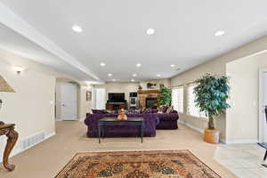 Carpeted living room featuring a fireplace