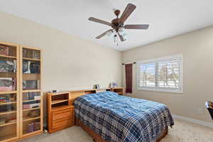 Bedroom featuring ceiling fan and light carpet