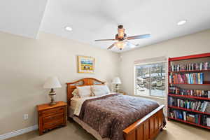 Bedroom featuring ceiling fan and light carpet