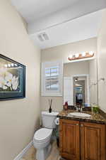 Bathroom featuring tile patterned floors, vanity, and toilet