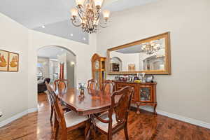 Dining space featuring an inviting chandelier and hardwood / wood-style floors