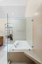 Bathroom featuring ceiling fan, separate shower and tub, tile patterned flooring, lofted ceiling, and vanity