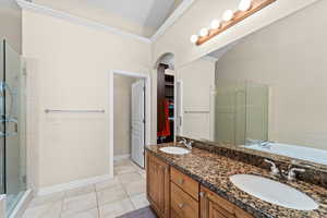 Bathroom with independent shower and bath, tile patterned flooring, lofted ceiling, and vanity