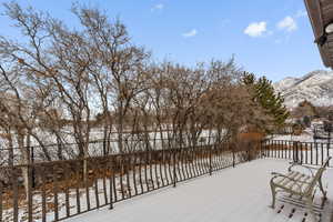 Snow covered deck with a mountain view