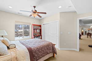 Bedroom featuring ceiling fan, a closet, and carpet floors