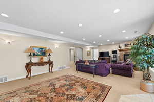 Carpeted living room featuring a fireplace