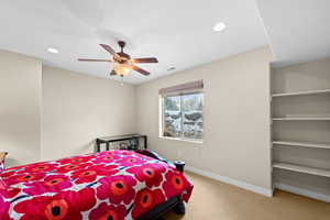 Bedroom featuring ceiling fan and carpet