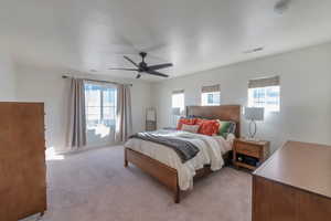 Bedroom featuring ceiling fan and light carpet