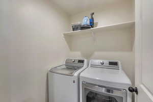 Washroom with washing machine and clothes dryer