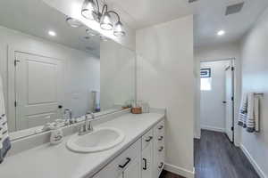 Bathroom with vanity and wood-type flooring