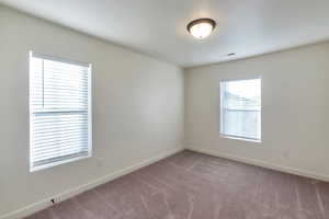 Unfurnished room with carpet