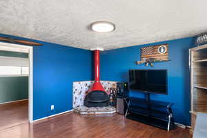 Interior space with a textured ceiling and dark hardwood / wood-style floors