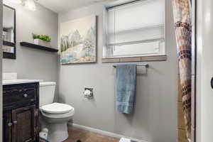 Bathroom featuring tile patterned floors, toilet, and vanity