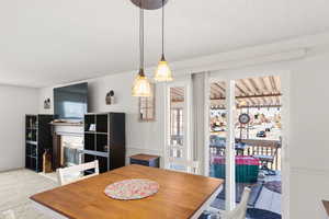 Carpeted dining space featuring a textured ceiling