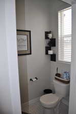 Bathroom with toilet and tile patterned flooring