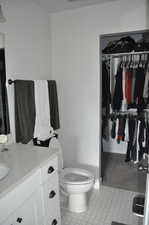 Bathroom featuring toilet, vanity, and tile patterned floors