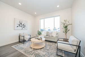 Living room with dark hardwood / wood-style floors