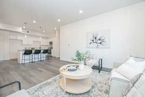 Living room with sink and light hardwood / wood-style flooring