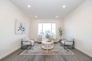 Sitting room with dark hardwood / wood-style floors