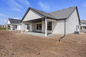 Back of property with central air condition unit and a patio area