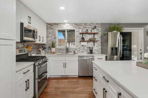 Backsplash is glass tiles. Gas stove, dishwasher and fridge included.