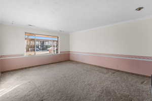 Living room featuring carpet floors and ornamental molding