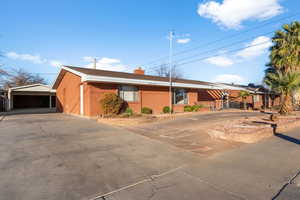 View of ranch-style house circle driveway detached garage