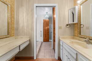 Primary Bathroom with tile patterned flooring and vanity