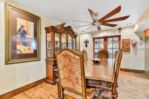 Dining space with ceiling fan, light hardwood / wood-style flooring, and french doors