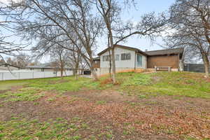 Back of house featuring a yard