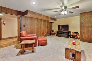 Family room featuring a ceiling fan, light colored carpet