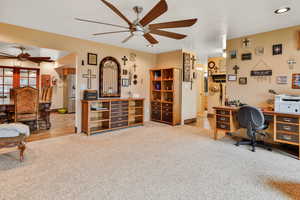 Living room with carpet floors and ceiling fan