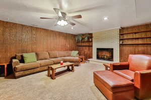 Family room with carpet floors, a fireplace, and a textured ceiling