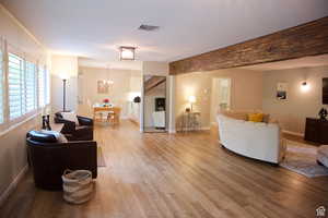 Living room with a notable chandelier and hardwood / wood-style floors