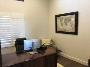 Office with baseboards and wood finished floors