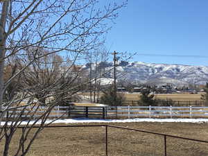 View of yard featuring fence and a mountain view